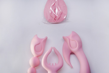 Bright sex toys on white background in the studio 