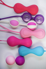 Bright sex toys on white background in the studio 