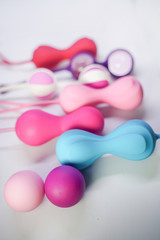 Bright sex toys on white background in the studio 