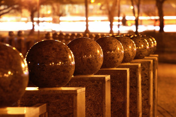 Polished granite balls at night. Abstract detail of urban realm.