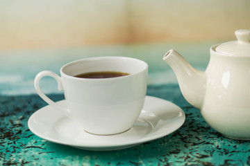 A cup of hot tea with different colours background.