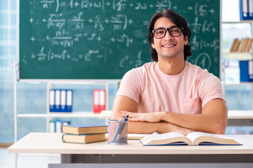 Young male student in the classroom 