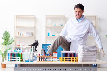 Young male chemist working in the lab