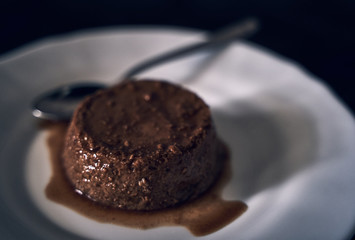 Coffee flan dessert on a dark natural wood background