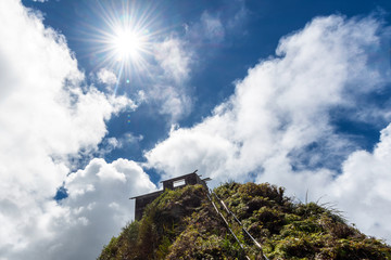 Direct shot at sun from a ridge trail on Oahu, Hawaii overlooking Kaneohe, Kailua and the windward side of the island