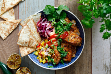 Mexican style bowl with fish, mango salsa and tortilla