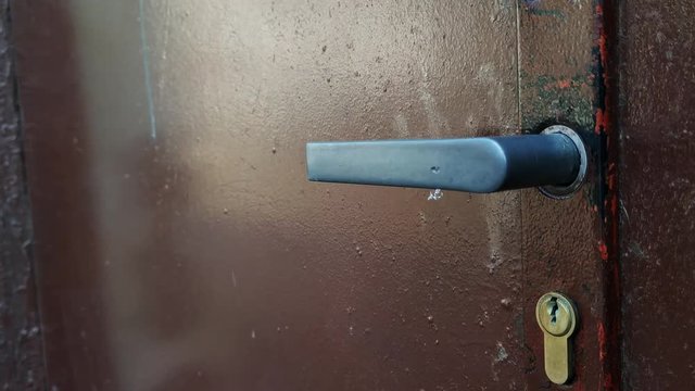 Pan down of old rustic door to door handle from Soviet time