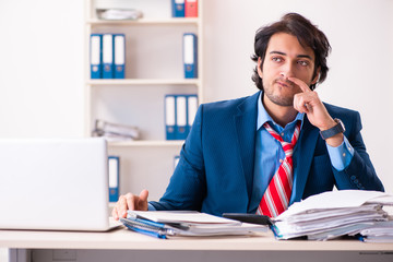 Young handsome businessman sitting in the office 