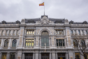 Fototapeta na wymiar Historical building of Banco de Espana - Bank of Spain seen from Cybele Square in Madrid, capital city of Spain