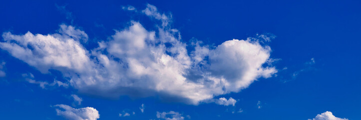 Naklejka na ściany i meble White clouds on blue background in the sky. panorama