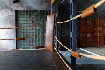 View of empty boxing ring in gym. Boxing corner braided Rope Boxing gym
