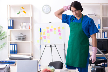 Male handsome professional cleaner working in the office 