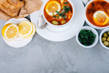 Solyanka a thick soup of vegetables and meat served with lemon and olives
