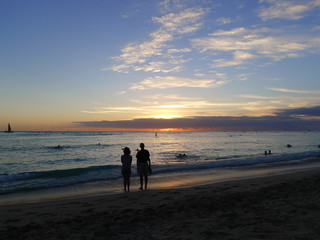Sunset at the Waikiki Beach on Oahu, Hawaii with silhouettes of people in the foreground