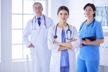 Group of doctors and nurses standing in the hospital room
