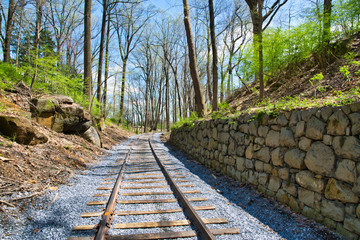 Fototapeta na wymiar New Rail Road Track on 1830's Right of Way with Stone Wall