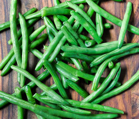 Green beans on a wooden background