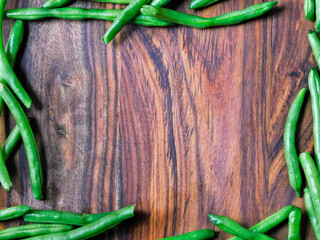 Green bean frame on wooden cutting board