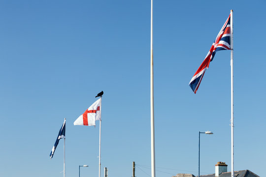 Black Raven Sitting on the Top of Englands Flag Post