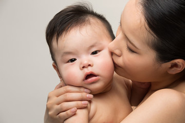 赤ちゃんにキスをする母親