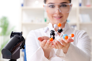 Young female chemist working in the lab 