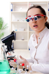 Young female chemist working in the lab 