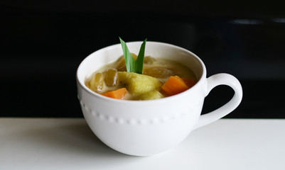 Indonesian sweet desserts or kolak on black background. 