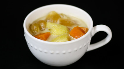 Indonesian sweet desserts or kolak on black background. 