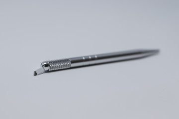 Microblading pens with blades and needles isolated on a white background