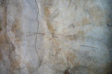 vertical with horizontal cracks and discoloration in concrete wall,grunge cement background.