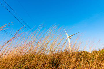 The mountain wind turbines in the sunrise and sunset in the sea of clouds