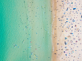 Bondi Beach aerial view on a perfect summer day with people swimming and sunbathing. Bondi is one...