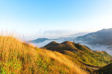 The mountain wind turbines in the sunrise and sunset in the sea of clouds