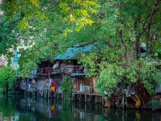 Fototapeta na wymiar Bangkok, Thailand, April 4, 2019 : Old wooden houses in the riverside community
