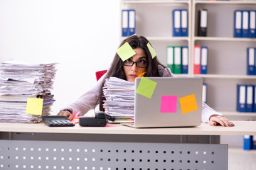 Young female employee in conflicting priorities concept 