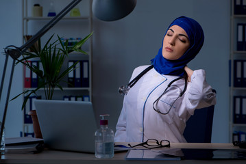 Arab female doctor working in the clinic at night 