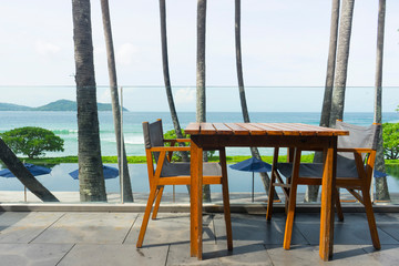 A table with chairs under a canopy on the beach. 
