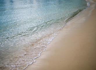 Sand beach with wave of the sea.
