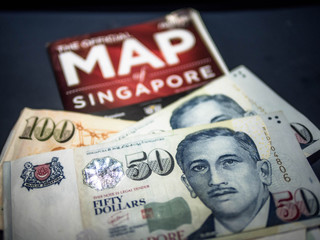 Trip to Singapore concept - Singapore dollar and map of Singapore.