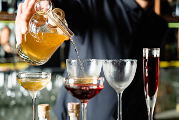 barman making cocktails