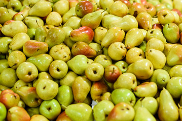 Pile of fresh pears at the market, close up.