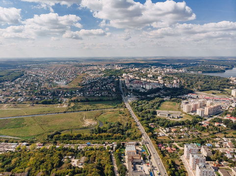 landscape view over city on summer sunny day with clouds aerial and view to lake