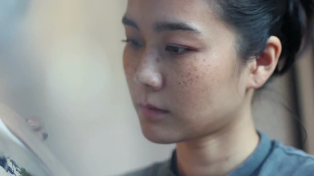 Young asian woman doing craft art work, design an accessories and put prototype on the wood board