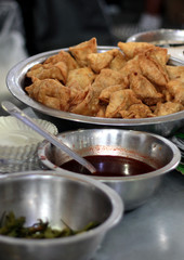 Closeup of Indian street food vendor arrangement in the stall,with samosa, sauce and other ingredients