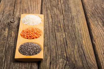 white rice, red lentil, chia seeds, old wooden table