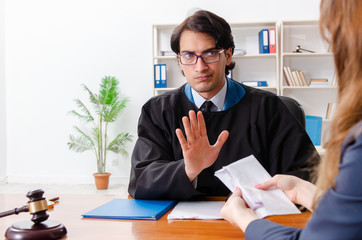 Young woman visiting male lawyer 