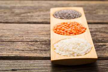 white rice, red lentil, chia seeds, old wooden table