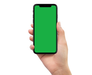 Human right hand holding black mobile smartphone with green screen