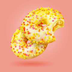 Yellow donut isolated on the coral color background