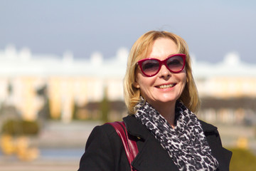 Woman in the park of Petergof, with a map in her hands. Spring sunny day